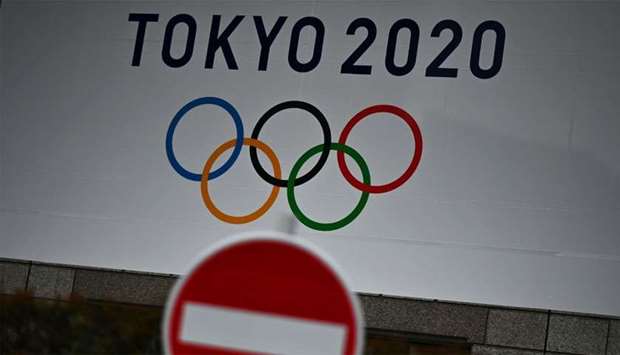The Tokyo 2020 logo is pictured next to a ,do not enter, street sign in Tokyo