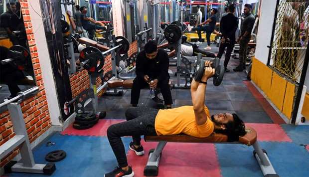 A patron exercises in a gym in New Delhi