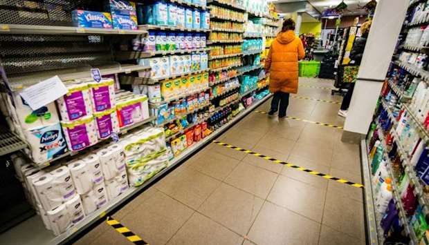 A customer walks in a supermarket with security distance marks on the floor in Engelen as a measure against the spread of the novel coronavirus (COVID-19).