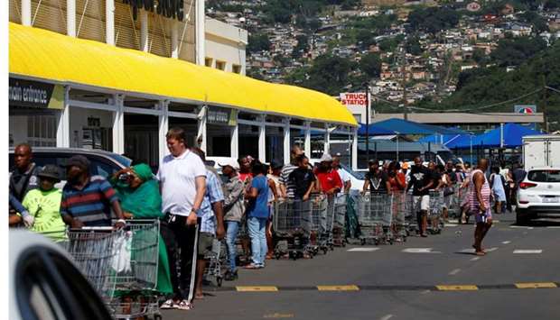 Shoppers queue to stock up on groceries at a Makro Store ahead of a nationwide 21 day lockdown in an attempt to contain the coronavirus disease (COVID-19) outbreak in Durban, South Africa