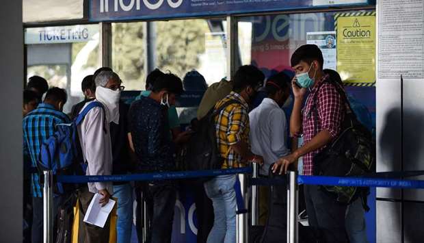 People lineup at an IndiGo Airlines ticket counter at the Sardar Vallabhbhai Patel Airport in Ahmedabad yesterday. The Ministry of Civil Aviation said all domestic flights would be shut down from midnight today.