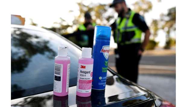 Disinfectant products are seen on a car whilst motorists fill out paperwork for police as they cross back into South Australia from Victoria during the coronavirus disease outbreak, in Bordertown, Australia.