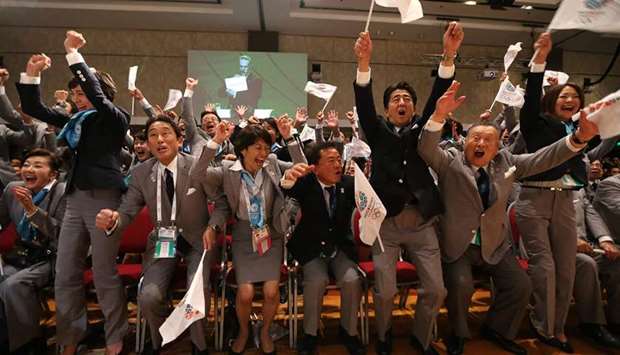In this file photo taken on September 7, 2013, Japanese Prime Minister Shinzo Abe (third right) celebrates alongside Tokyo 2020 delegation members after IOC president Jacques Rogge announced the Japanese capital to be the winner of the bid to host the 2020 Summer Olympic Games in Buenos Aires. (AFP)