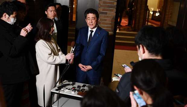 Japanu2019s Prime Minister Shinzo Abe speaks to the press in front of his residence in Tokyo yesterday.