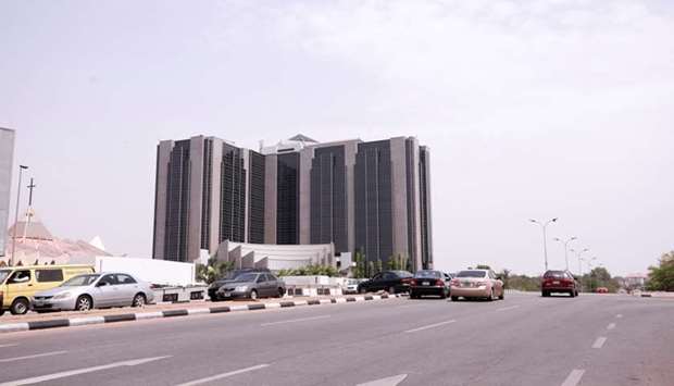 Some cars drive past the Central Bank of Nigeria headquaters in Abuja, Nigeria