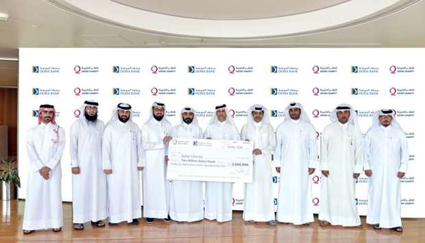 Doha Bank and Qatar Charity officials during the ceremonial handing over of the QR2mn cheque