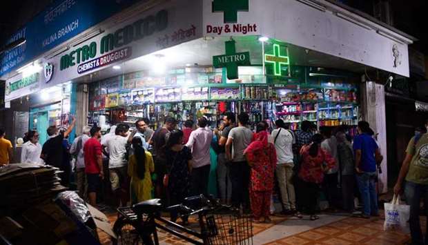 People gather at a pharmacy to buy supplies following Prime Minister Narendra Modiu2019s announcement of a government-imposed nationwide lockdown as a preventive measure against the Covid-19 in Mumbai yesterday.