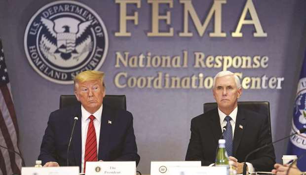 US President Donald Trump (left) and US Vice President Mike Pence listen during a roundtable meeting at the Federal Emergency Management Agency (Fema) headquarters in Washington, DC.