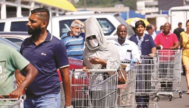 Shoppers queue to stock up on groceries at a Makro Store ahead of the nationwide 21-day lockdown in an attempt to contain the coronavirus disease outbreak in Durban on March 24.
