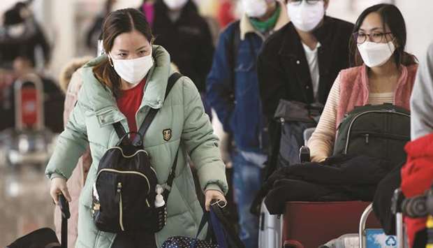 Passengers wearing masks walk at Incheon International Airport in Incheon, South Korea. Aviation continues to grapple with the Covid-19 pandemic, its largest crisis in the history of commercial flight.