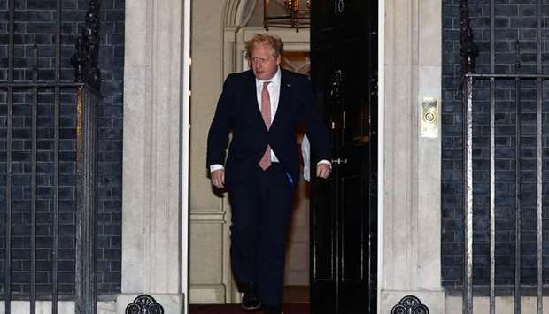 Britain's Prime Minister Boris Johnson as he walks out of the door of 10 Downing Street before applauding during the Clap For Our Carers campaign in support of the NHS, as the spread of the coronavirus disease (COVID-19) continues, London, Britain