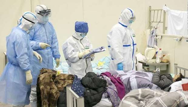 Medical staff check a patientu2019s condition at a temporarily converted hospital for coronavirus patients in Wuhan.
