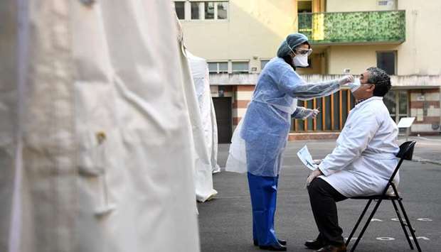 A pharmacist has samples taken at a Covid-19 screening centre reserved for health professionals on March 27, 2020 in Paris, as the country is under lockdown to stop the spread of the Covid-19 pandemic.