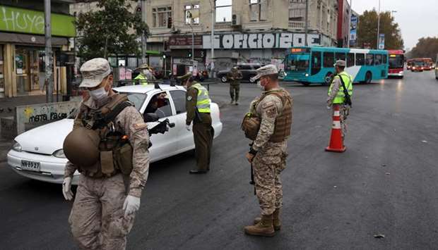 Soldiers and police officers carry out checks at a health checkpoint, during a preventive quarantine following the outbreak of coronavirus disease, in Santiago, Chile, yesterday.