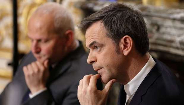French Minister for Solidarity and Health Olivier Veran March looks on during a news conference in Paris, France on Saturday, on the eleventh day of a strict nationwide confinement seeking to halt the spread of Covid-19.