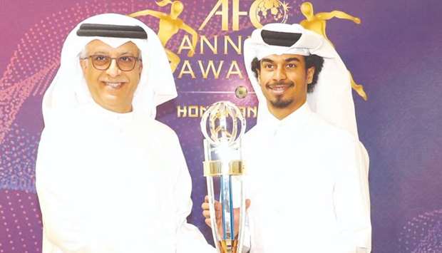 In this December 10, 2019, picture, Qataru2019s Akram Afif (right, also left) receives the AFC Player of the Year Award from Asian Football Confederation President Sheikh Salman bin Ebrahim al-Khalifah.