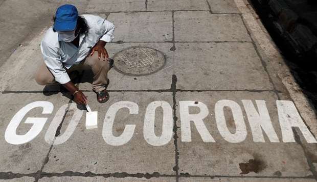 A man paints a message on a street in Mumbai yesterday.