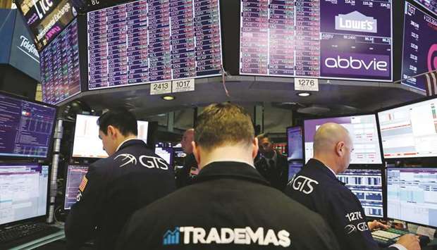 Traders work on the floor of the New York Stock Exchange (file). Money managers rebalancing their portfolios to boost equity exposure into the end of the quarter may support the nascent stock rally that has followed the steep coronavirus-fuelled market drop.