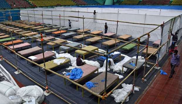 Workers install beds to set up a quarantine facility inside Sarusajai Sports Complex in Guwahati, Assam yesterday.
