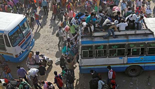 Migrant workers travel on crowded buses as they return to their villages, in Ghaziabad yesterday.