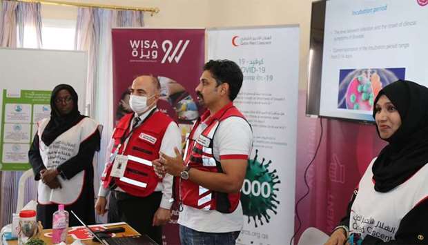 Officials of Qatar Manpower Solutions Company (WISA), and the Qatar Red Crescent Society making a presentation.