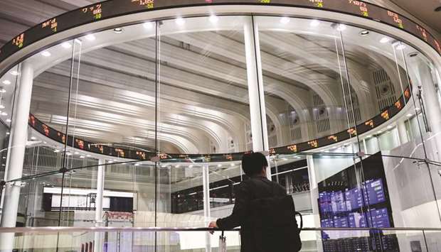 An electronic ticker displays share prices at the Tokyo Stock Exchange. The Nikkei 225 index closed down 1.6% to 19,084.97 points yesterday.