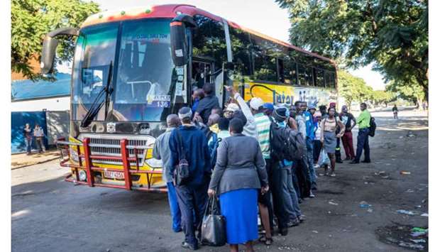 People board a commuter bus in Bulawayo yesterday.