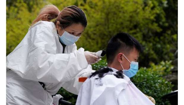 Barber Xiong Juan, 39, cuts a customeru2019s hair at a residential compound in Wuhan.