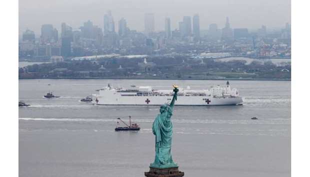 The USNS Comfort passes the Statue of Liberty as it enters New York Harbor yesterday.