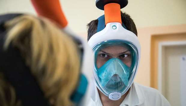 Medical workers from Motol hospital wear snorkel masks transformed into high-grade protection by researchers from The Czech Institute of Informatics, Robotics and Cybernetics at Czech Technical University in Prague, Czech Republic