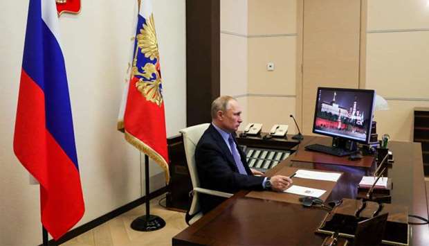 Russian President Vladimir Putin attends a meeting with regional officials via tele link in his residence outside Moscow