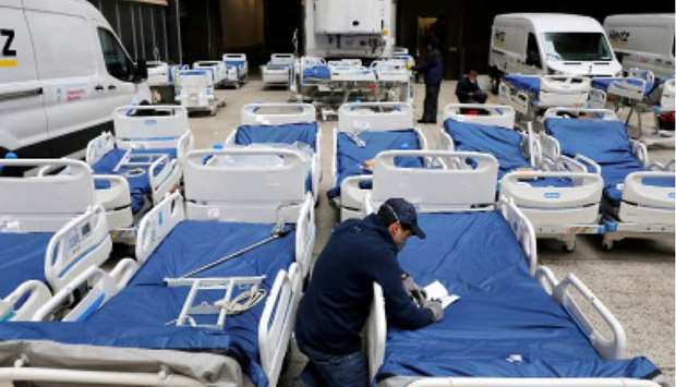 A worker checks part of a delivery of 64 hospital beds from Hillrom to The Mount Sinai Hospital in Manhattan, New York City.