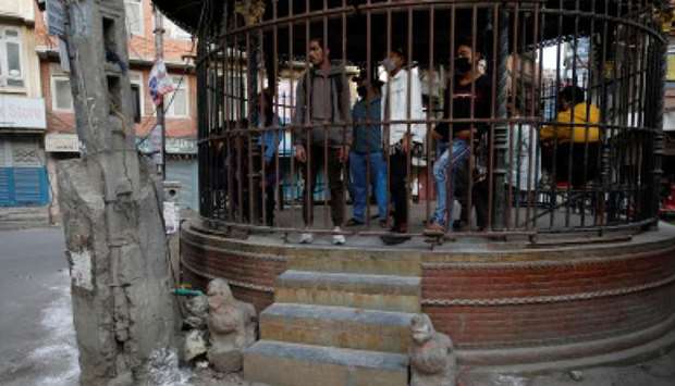 People defying the lockdown are put inside an enclosure along the street, as a punishment during the eighth-day of the lockdown imposed by the government amid concerns about the spread of coronavirus disease (Covid-19) outbreak, in Kathmandu yesterday.