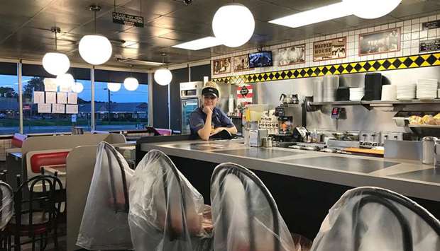 UNDER THE WEATHER: Tristan Thurman, 22, a Waffle House server, is struggling to earn money as her restaurant in Cartersville, Georgia takes only to-go orders and has cut her hours.