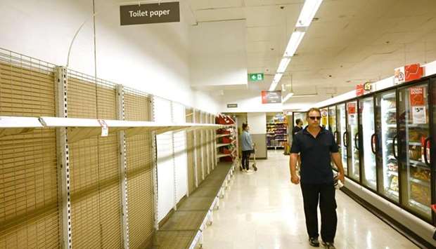 Shelves are empty of toilet rolls in a supermarket in Sydney