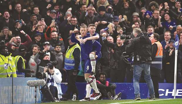 Chelseau2019s Ross Barkley (left) celebrates with teammate Billy Gilmour after scoring against Liverpool during the English FA Cup fifth round match at Stamford Bridge in London on Tuesday night. (AFP)