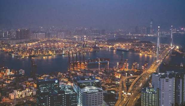 Lights illuminate the port and container terminal at night in Hong Kong.