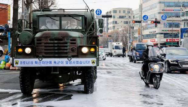 A military vehicle disinfects a road to prevent the spread of coronavirus in Seoul, South Korea