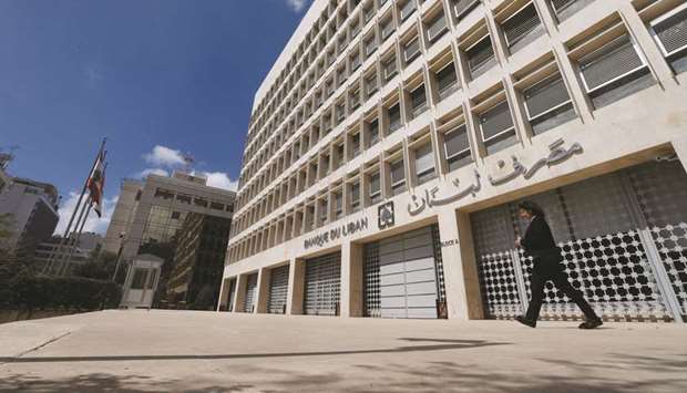A woman walks outside of Lebanonu2019s central bank building in Beirut.
