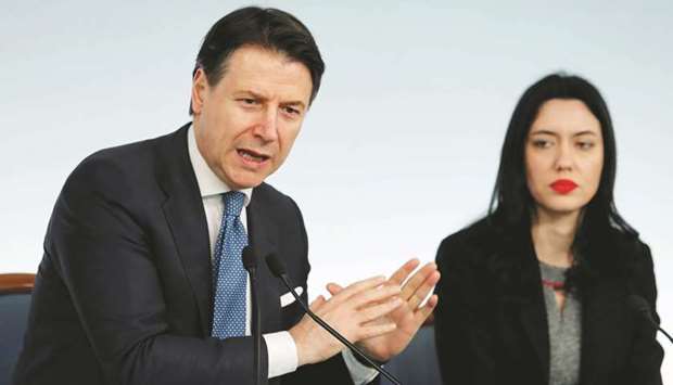 Italian Prime Minister Giuseppe Conte and Education Minister Lucia Azzolina address the media in Rome yesterday, announcing a decree that will close cinemas, schools in order to contain the spread of coronavirus.