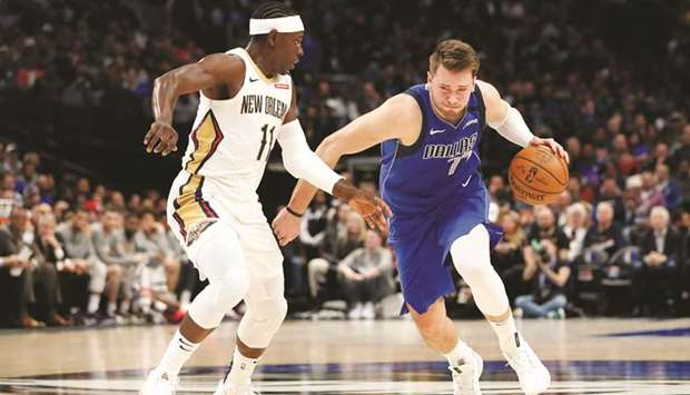 Dallas Mavericksu2019 Luka Doncic (right) drives to the basket past New Orleans Pelicansu2019 Jrue Holiday during the second quarter at American Airlines Center. PICTURE: USA TODAY Sports