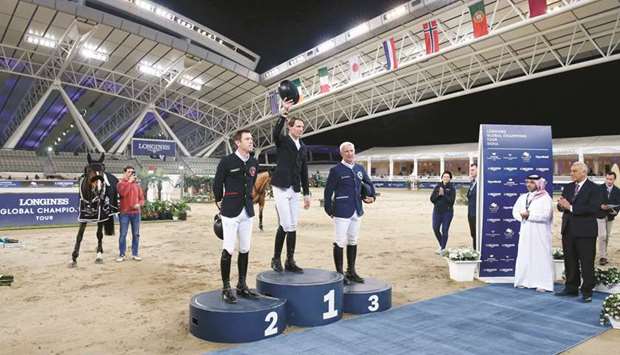 Franceu2019s Kevin Staut (centre) celebrates after winning the feature event on the opening day of the Longines Global Champions Tour at the Longines Arena at Al Shaqab yesterday. Britainu2019s Scott Brash (left) finished second, while Frenchman Roger-Yves Bost was third.