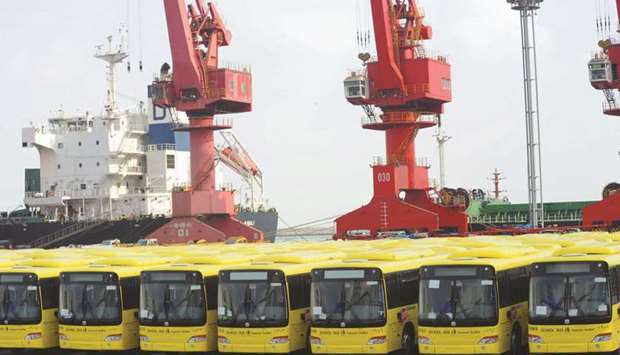 Buses wait to be exported in Lianyungang port. Chinau2019s exports are expected to have sunk 14% in January-February from a year earlier, according to a median estimate from the survey of 25 economists, marking the steepest fall since February 2019.