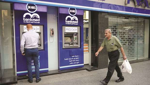 A man walks past a closed bank office in Beirut (file). Once central to how the government managed public finances, Lebanonu2019s banks are now the focus of its ire as the clock runs down to the March 9 deadline for repaying $1.2bn in Eurobonds.