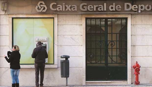 A customer uses an ATM outside a CaixaBank branch in Lisbon. CaixaBank is the most exposed lender, with u20ac6.1bn ($6.7bn) of outstanding mortgages linked to the Spanish central banku2019s Loan Reference Index, or IRPH.