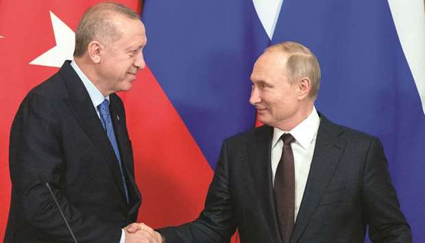 Russian President Vladimir Putin and Turkish President Tayyip Erdogan shake hands during a news conference following their talks in Moscow, Russia, yesterday.