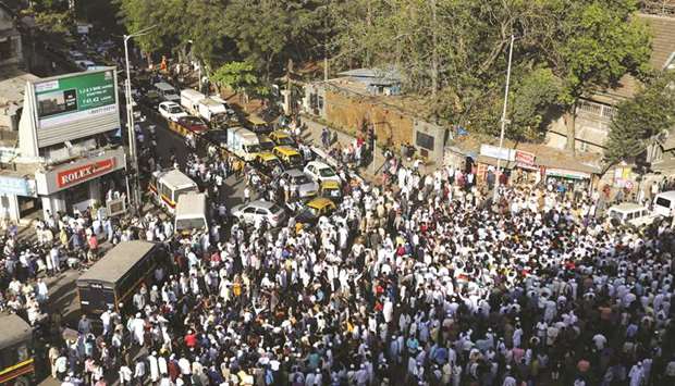 Demonstrators block a road during a protest against Mumbai police after they allegedly manhandled protesters at a sit in protest against a new citizenship law in Mumbai yesterday.