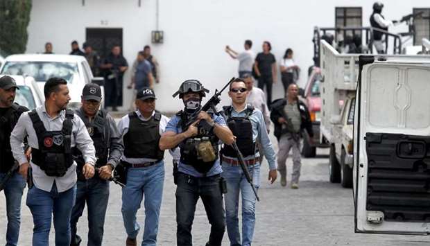 Police members patrol during an operation after two ministerial agents, 6 kidnapped people and a civilian lost their lives during a confrontation in the La Huertas neighborhood in Tlaquepaque, Mexico