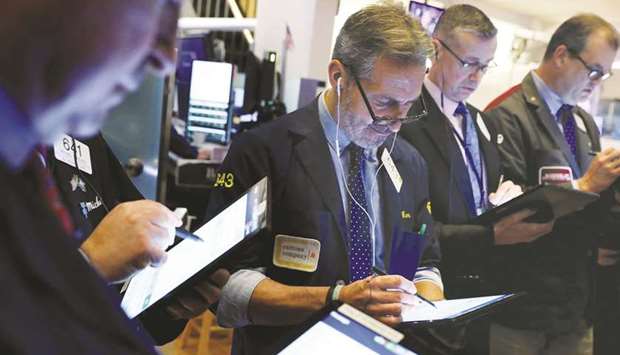 Traders work on the floor at the New York Stock Exchange. Bargain-hunting investors are eyeing the shares of airlines, hotels, cruise lines and other companies that have been among the worst-hit by the coronavirus outbreak.