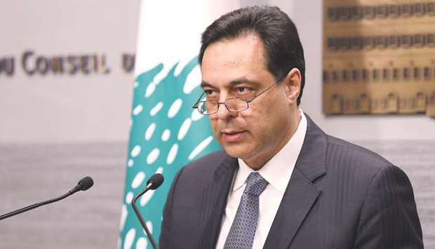 Lebanonu2019s Prime Minister Hassan Diab speaks during a televised address to the nation at the governmental palace in Beirut yesterday. Foreign currency reserves have fallen to u201ca worrying and dangerous level which pushes the Lebanese government to suspend payment of the March 9 Eurobond maturity because of a need for these funds,u201d Diab said.